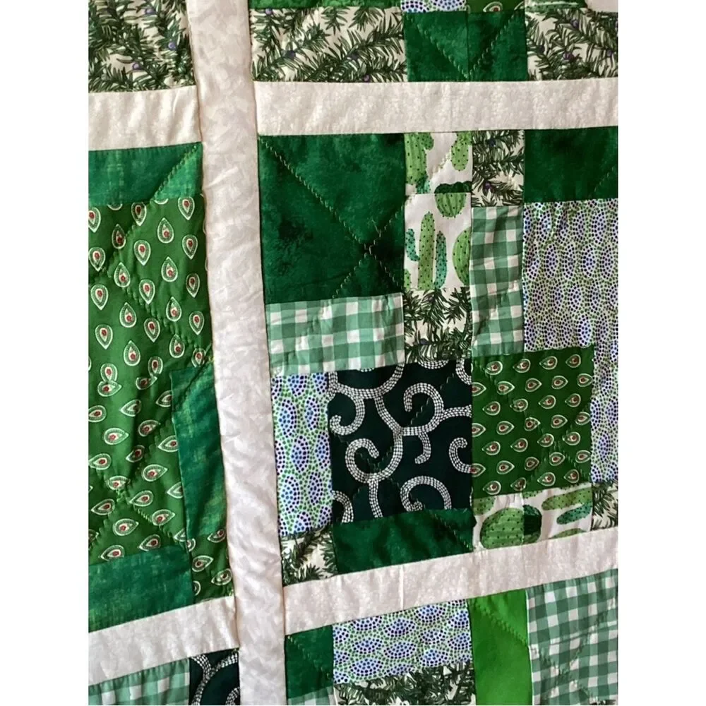 New without tags. Medley of Green Fabrics with White Borders Quilt